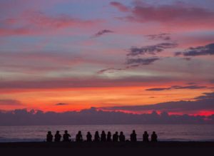 group on beach at sunset
