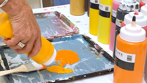 squeezing out orange paint