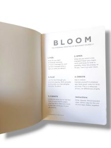 Open book page titled BLOOM with a subtitle and numbered sections (Feel, Open) visible in a clean layout.